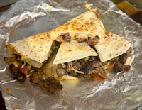 a quesadilla is sitting on a piece of foil